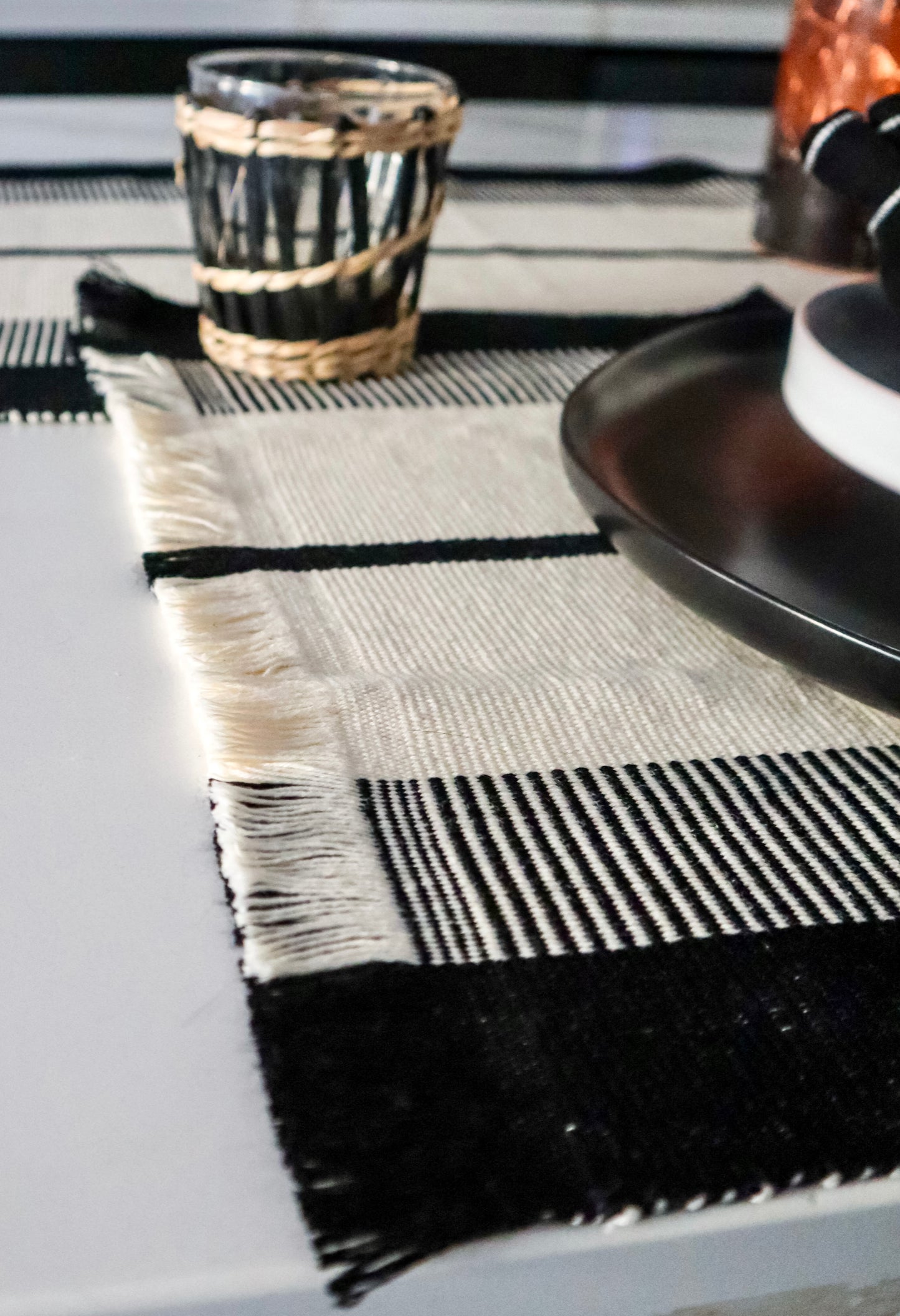 Fringed crème & black placemat